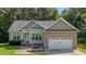 Charming single Gathering home featuring a brick and vinyl exterior, attached two car garage, and well maintained lawn at 46 Trusting Ln, Middlesex, NC 27557