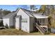 Gray house exterior with a wooden deck and stairs leading to the back at 46 Trusting Ln, Middlesex, NC 27557