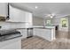 Bright kitchen featuring white cabinets, granite countertops, and stainless-steel appliances at 46 Trusting Ln, Middlesex, NC 27557