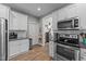 Modern kitchen featuring white cabinets and stainless steel appliances at 46 Trusting Ln, Middlesex, NC 27557