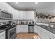 White kitchen with granite countertops and stainless steel appliances at 46 Trusting Ln, Middlesex, NC 27557
