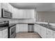 A modern kitchen featuring white cabinets, stainless steel appliances, and dark countertops at 46 Trusting Ln, Middlesex, NC 27557