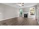 A bright living room featuring hard floors, a fireplace, and natural light from surrounding windows at 46 Trusting Ln, Middlesex, NC 27557