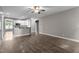 Open concept living room with hardwood floors connecting to the modern kitchen area at 46 Trusting Ln, Middlesex, NC 27557