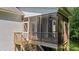Back of home featuring a large screened in porch and a wooden deck with stairs to the backyard at 46 Trusting Ln, Middlesex, NC 27557