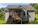 Back of home featuring a large screened in porch and a wooden deck with stairs to the backyard at 46 Trusting Ln, Middlesex, NC 27557