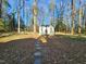 Wooded backyard with shed and stone pathway at 4909 Old Elizabeth Rd. Rd, Raleigh, NC 27616