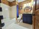 Updated bathroom with hexagon tile floor and navy vanity at 4909 Old Elizabeth Rd. Rd, Raleigh, NC 27616