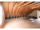 Spacious unfinished attic with wooden beams, offering potential for customization and additional living space at 496 Omaha Dr, Broadway, NC 27505