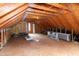 Unfinished attic space featuring exposed wooden beams and ample room for storage or conversion at 496 Omaha Dr, Broadway, NC 27505