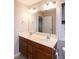 Bathroom features double sink vanity, neutral walls, window and bright light fixtures at 496 Omaha Dr, Broadway, NC 27505