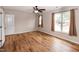 Bright bedroom with ceiling fan, wood floor, closet and large windows with views at 496 Omaha Dr, Broadway, NC 27505