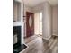Entryway with hardwood floors, fireplace, and burgundy front door at 496 Omaha Dr, Broadway, NC 27505