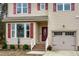 Two-story home with red shutters, a double garage, and a covered entry at 496 Omaha Dr, Broadway, NC 27505