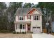 Two-story house with beige siding, red roof accents, and a burgundy front door at 496 Omaha Dr, Broadway, NC 27505