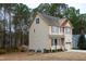 Two-story house with beige siding, red shutters, and a two-car garage at 496 Omaha Dr, Broadway, NC 27505