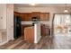 Kitchen features dark wood cabinets, stainless steel appliances, and vinyl flooring at 496 Omaha Dr, Broadway, NC 27505