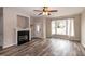 Living Room with hardwood floors, fireplace, and large windows at 496 Omaha Dr, Broadway, NC 27505