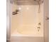 Shower Tub features neutral walls, white tile, shower head, water fixtures and built-in shelving at 496 Omaha Dr, Broadway, NC 27505