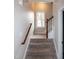 Carpeted staircase with wooden railing and a window at the top at 496 Omaha Dr, Broadway, NC 27505