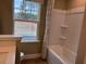 Clean bathroom featuring a shower/tub combo and window at 5112 N River Sand Trl, Raleigh, NC 27604