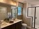 Double vanity bathroom with large shower and window at 5112 N River Sand Trl, Raleigh, NC 27604