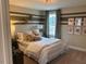 Bedroom with striped accent wall and comfortable bed at 5112 N River Sand Trl, Raleigh, NC 27604