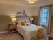 Cozy bedroom with a queen-size bed and yellow accents at 5112 N River Sand Trl, Raleigh, NC 27604