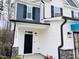 Front entrance with black door and stone accents at 5112 N River Sand Trl, Raleigh, NC 27604
