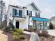 Two-story home with white siding, blue accents, and landscaping at 5112 N River Sand Trl, Raleigh, NC 27604