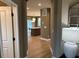 Bright hallway with hardwood floors and views into the kitchen and dining area at 5112 N River Sand Trl, Raleigh, NC 27604
