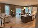 Open concept kitchen with island and stainless steel appliances at 5112 N River Sand Trl, Raleigh, NC 27604
