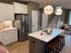 Open kitchen with large island and stainless steel refrigerator at 5112 N River Sand Trl, Raleigh, NC 27604