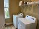 Bright laundry room featuring washer, dryer, and storage at 5112 N River Sand Trl, Raleigh, NC 27604