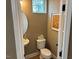 Small powder room with toilet and sink at 5112 N River Sand Trl, Raleigh, NC 27604