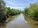 Serene river view with lush green trees and tranquil waters at 5112 N River Sand Trl, Raleigh, NC 27604