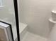 Shower with built-in seat and white tile at 5112 N River Sand Trl, Raleigh, NC 27604