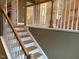 Elegant staircase with a wood and white design at 5112 N River Sand Trl, Raleigh, NC 27604