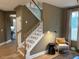 Modern staircase with white railings and wood steps at 5112 N River Sand Trl, Raleigh, NC 27604