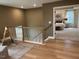 Upstairs hallway with view of bedroom and stairs at 5112 N River Sand Trl, Raleigh, NC 27604