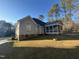 Beautiful backyard featuring a screened-in porch perfect for outdoor living, a lawn, and mature trees at 5637 Turner Glen Dr, Raleigh, NC 27603