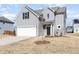 Beautiful two-story home features a white garage door, gray siding, and black front door at 57 Duchess Ave, Franklinton, NC 27525