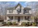 Two-story house with gray siding, white porch, and landscaping at 6224 Bridgemont Ln, Willow Springs, NC 27592