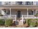 Charming front porch with rocking chairs and hanging planters at 6224 Bridgemont Ln, Willow Springs, NC 27592