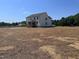 Exterior view of a home surrounded by spacious backyard with plenty of room for activities at 92 Frost Meadow Way, Lillington, NC 27546