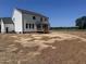 New construction with a covered deck and large open backyard, ready for landscaping at 92 Frost Meadow Way, Lillington, NC 27546