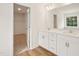 Bright bathroom featuring double sinks, white cabinetry, and a closet at 92 Frost Meadow Way, Lillington, NC 27546