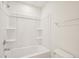 Clean bathroom featuring a bathtub with a shower and a towel rack at 92 Frost Meadow Way, Lillington, NC 27546