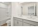 Bathroom featuring double sink vanity with drawers, a tub-shower combo and a wide mirror at 92 Frost Meadow Way, Lillington, NC 27546