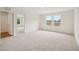 Sunlit bedroom with neutral carpet and light walls, and windows with a view outside at 92 Frost Meadow Way, Lillington, NC 27546
